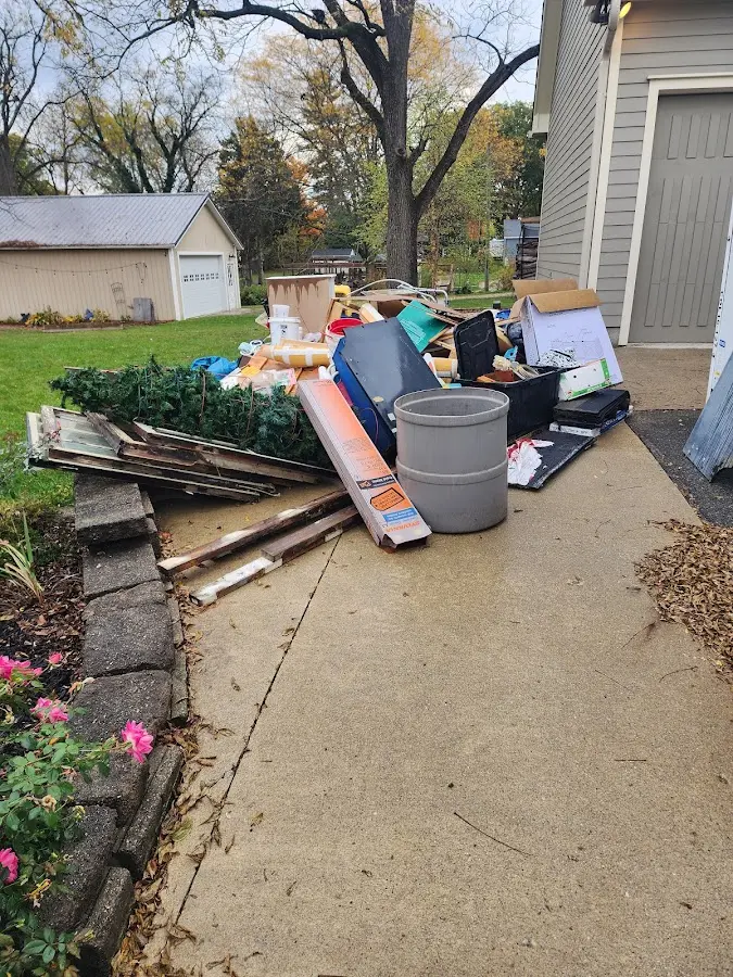 Dumpster being loaded with debris for Commercial Dumpster Rental in Belmont